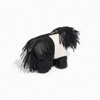 Black and white handbag with fringe details on a white background