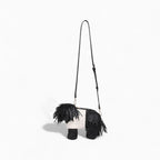 Black and white dog toy with fringes on a white background