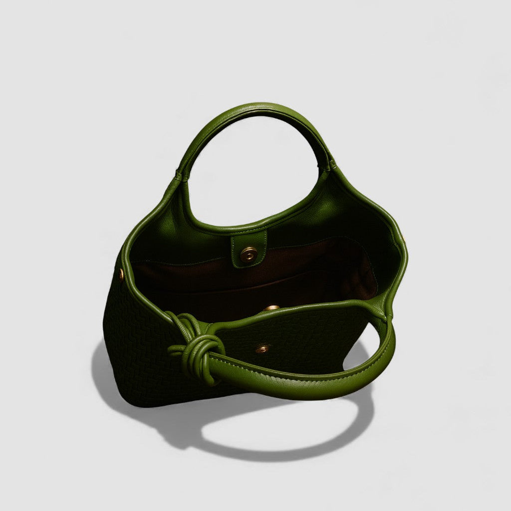 Green handbag on a light gray background